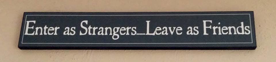 The Abbington Green sign reading Enter as Strangers, Leave as Friends